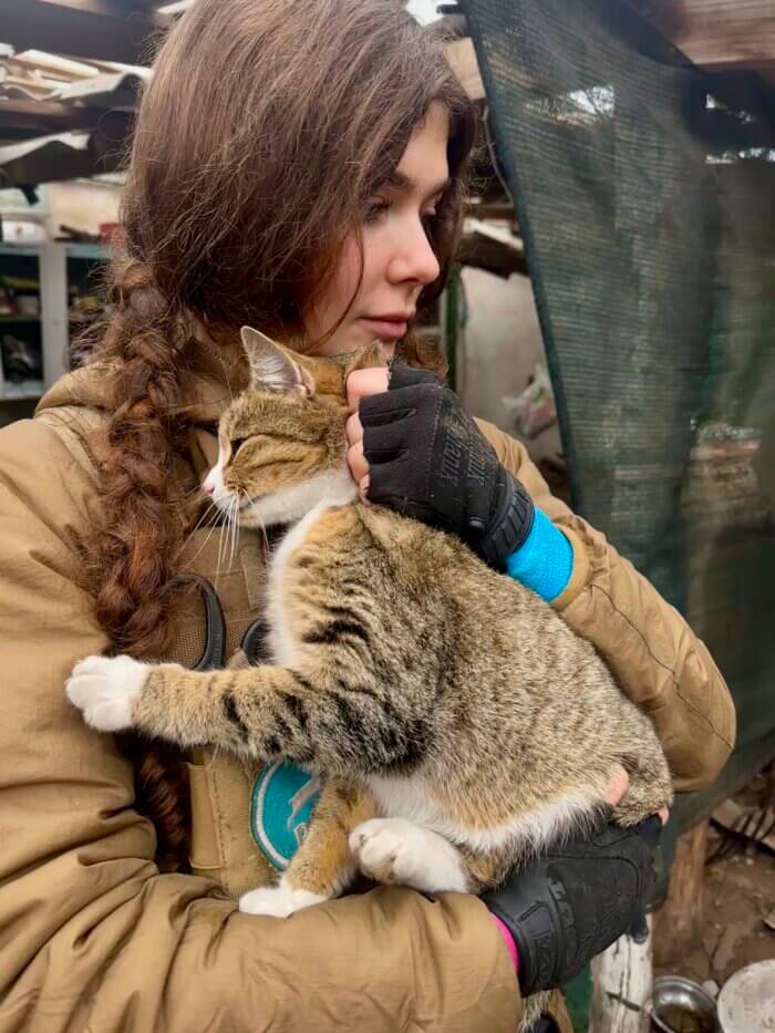 Frau mit geretteter Katze auf dem Arm
